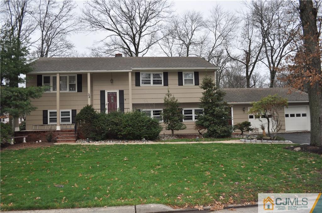 32 Nottingham Road Edison, NJ 08820 - Photo 2 of 25 a front view of a house with a yard and trees