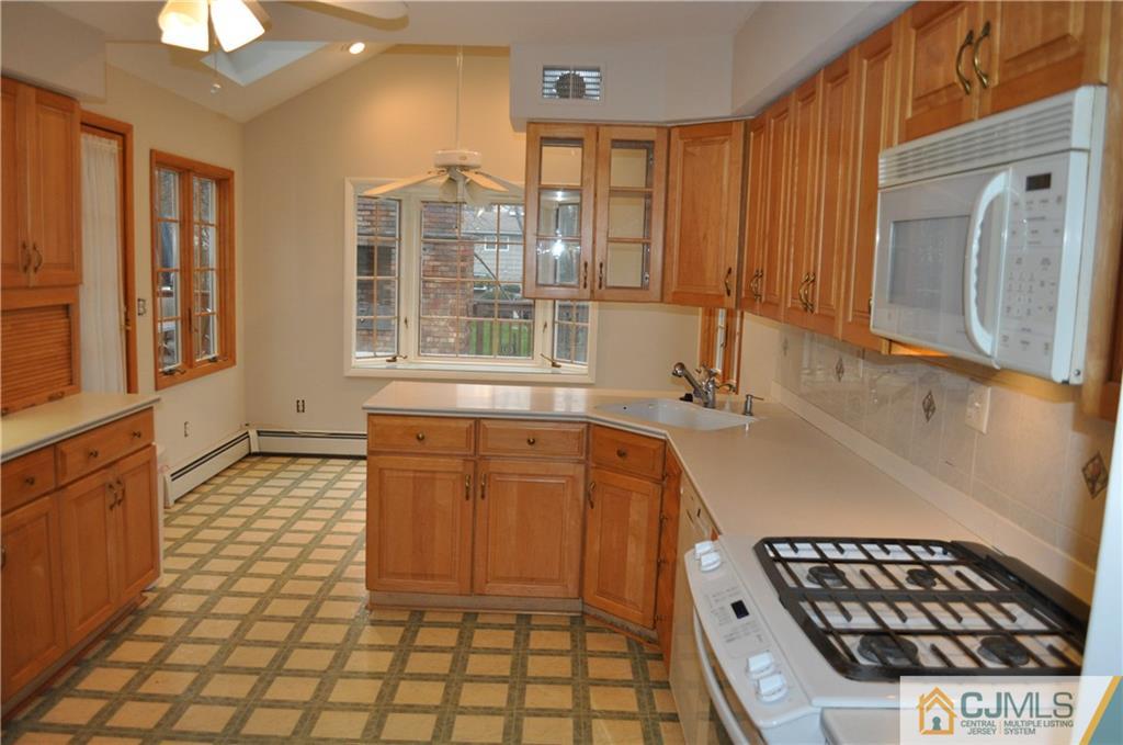 32 Nottingham Road Edison, NJ 08820 - Photo 11 of 25 a bathroom with a sink a mirror and a shower