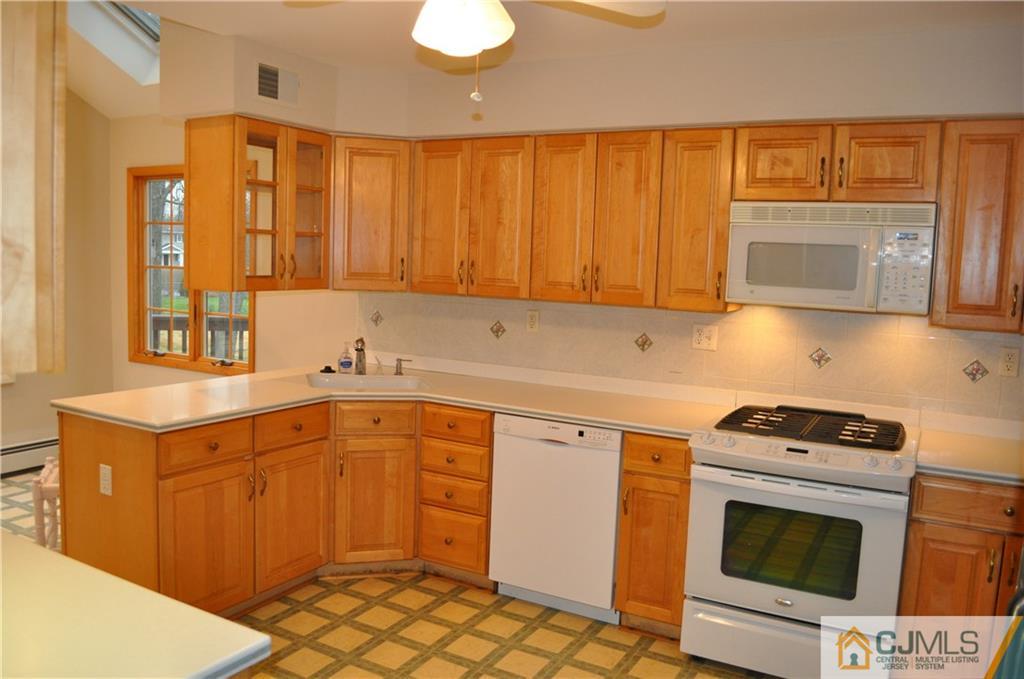 32 Nottingham Road Edison, NJ 08820 - Photo 12 of 25 a kitchen with stainless steel appliances granite countertop a stove a sink and a microwave