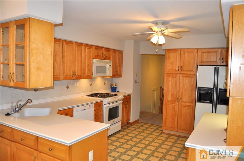 32 Nottingham Road Edison, NJ 08820 - Photo 15 of 25 a kitchen with a sink a stove and a refrigerator