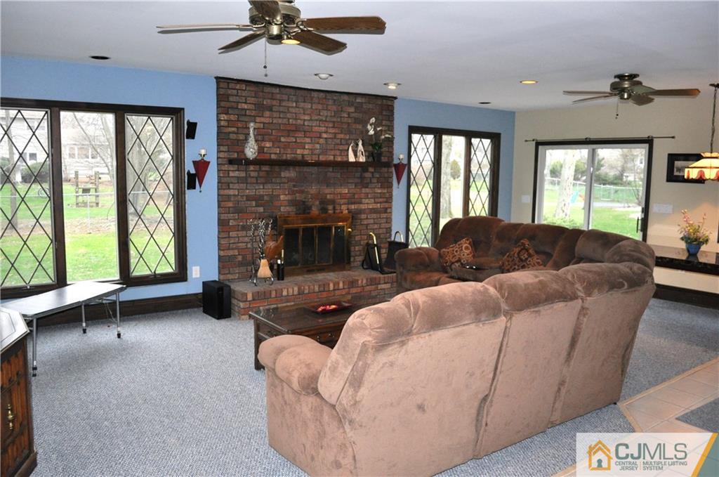 32 Nottingham Road Edison, NJ 08820 - Photo 23 of 25 a living room with furniture and a fireplace