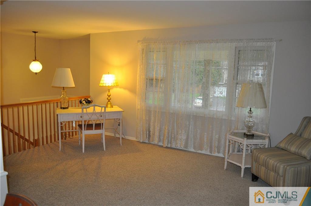 32 Nottingham Road Edison, NJ 08820 - Photo 7 of 25 a dining room with furniture and a chandelier
