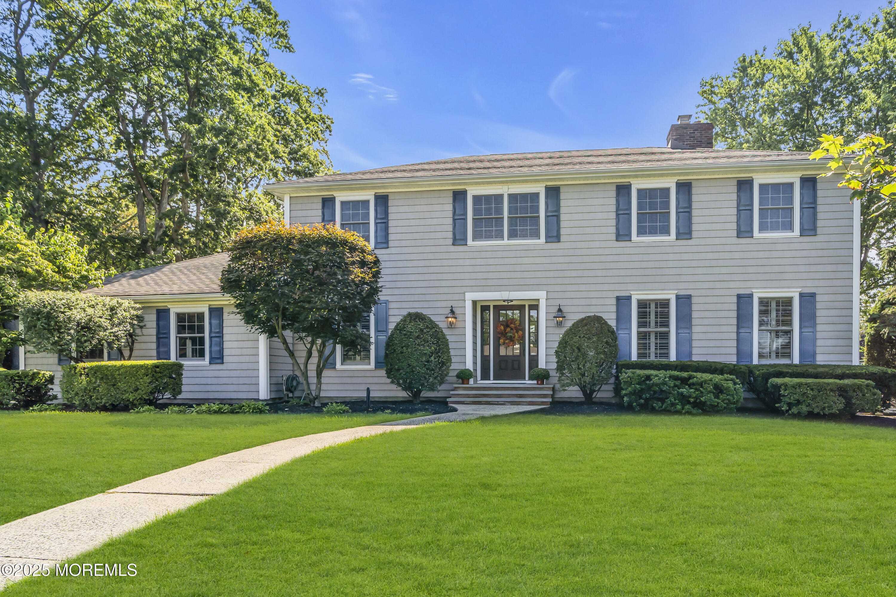 a front view of house with yard and green space