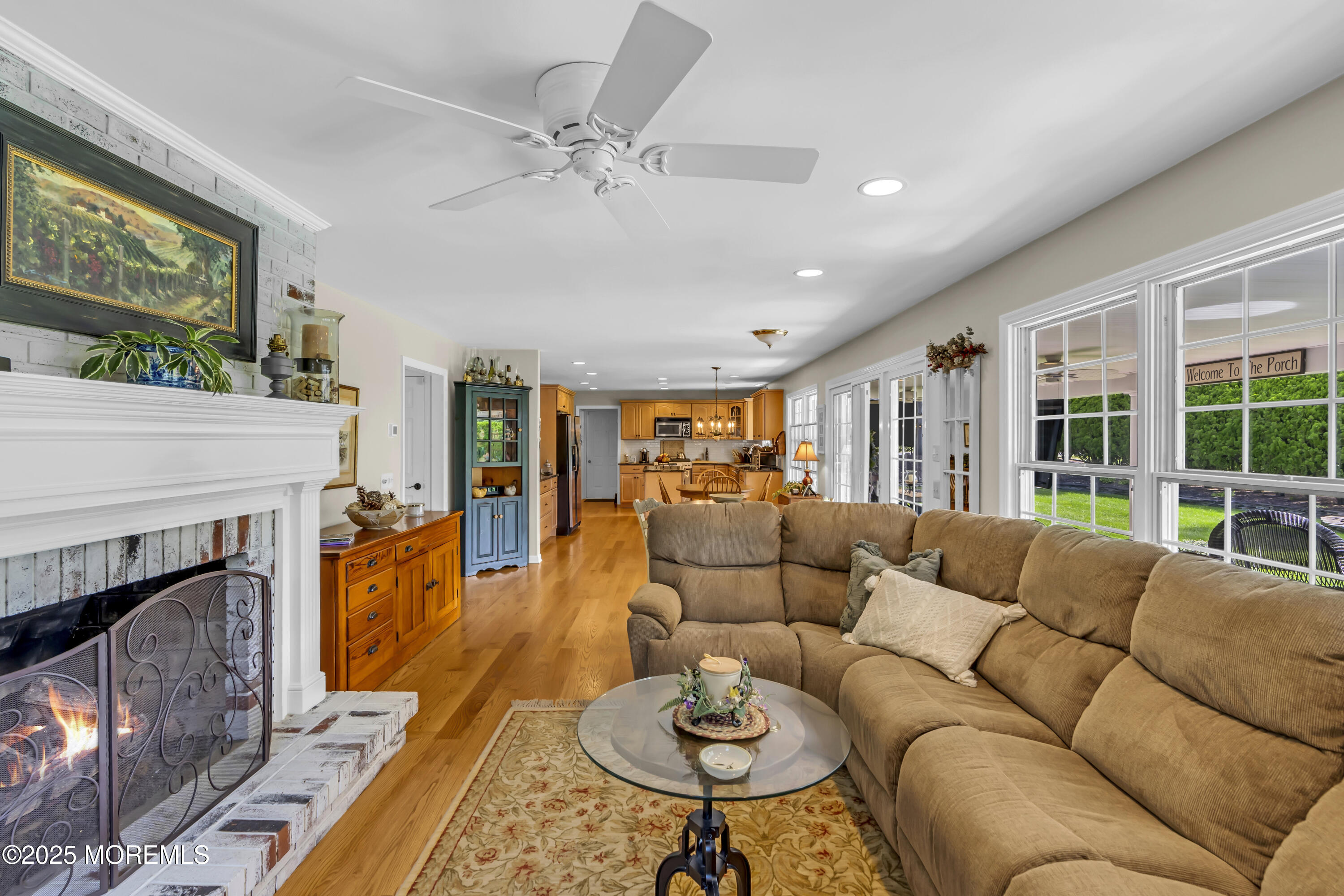 664 Valley Road Brielle, NJ 08730 - Photo 20 of 46 a living room with furniture a fireplace and a floor to ceiling window
