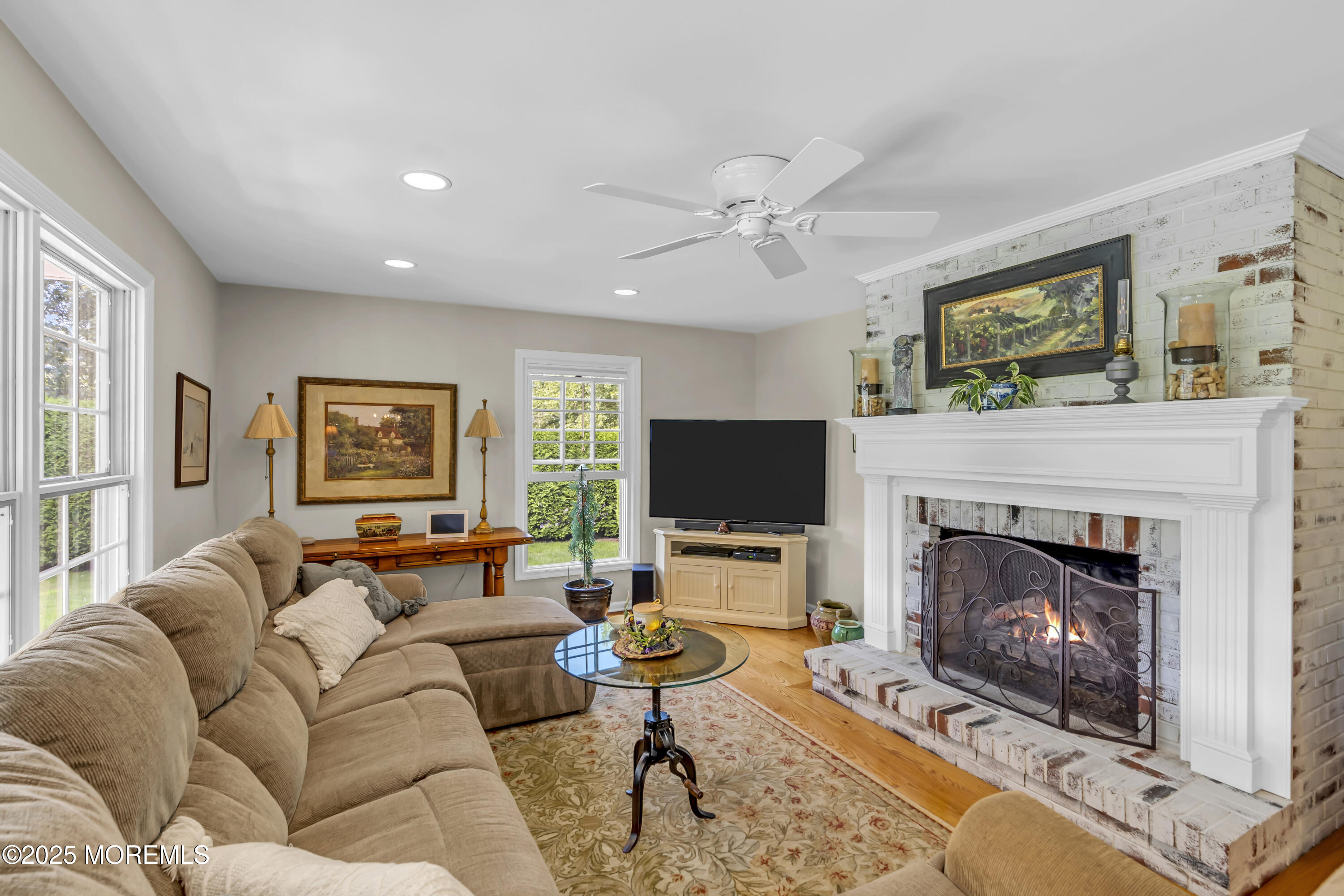664 Valley Road Brielle, NJ 08730 - Photo 21 of 46 a living room with furniture a fireplace and a flat screen tv