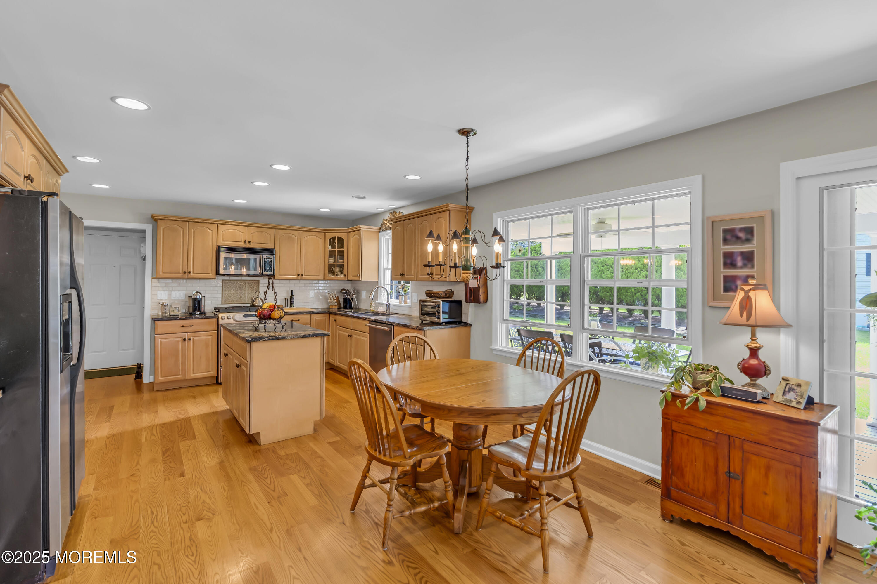 664 Valley Road Brielle, NJ 08730 - Photo 23 of 46 a dining room with furniture a chandelier and wooden floor