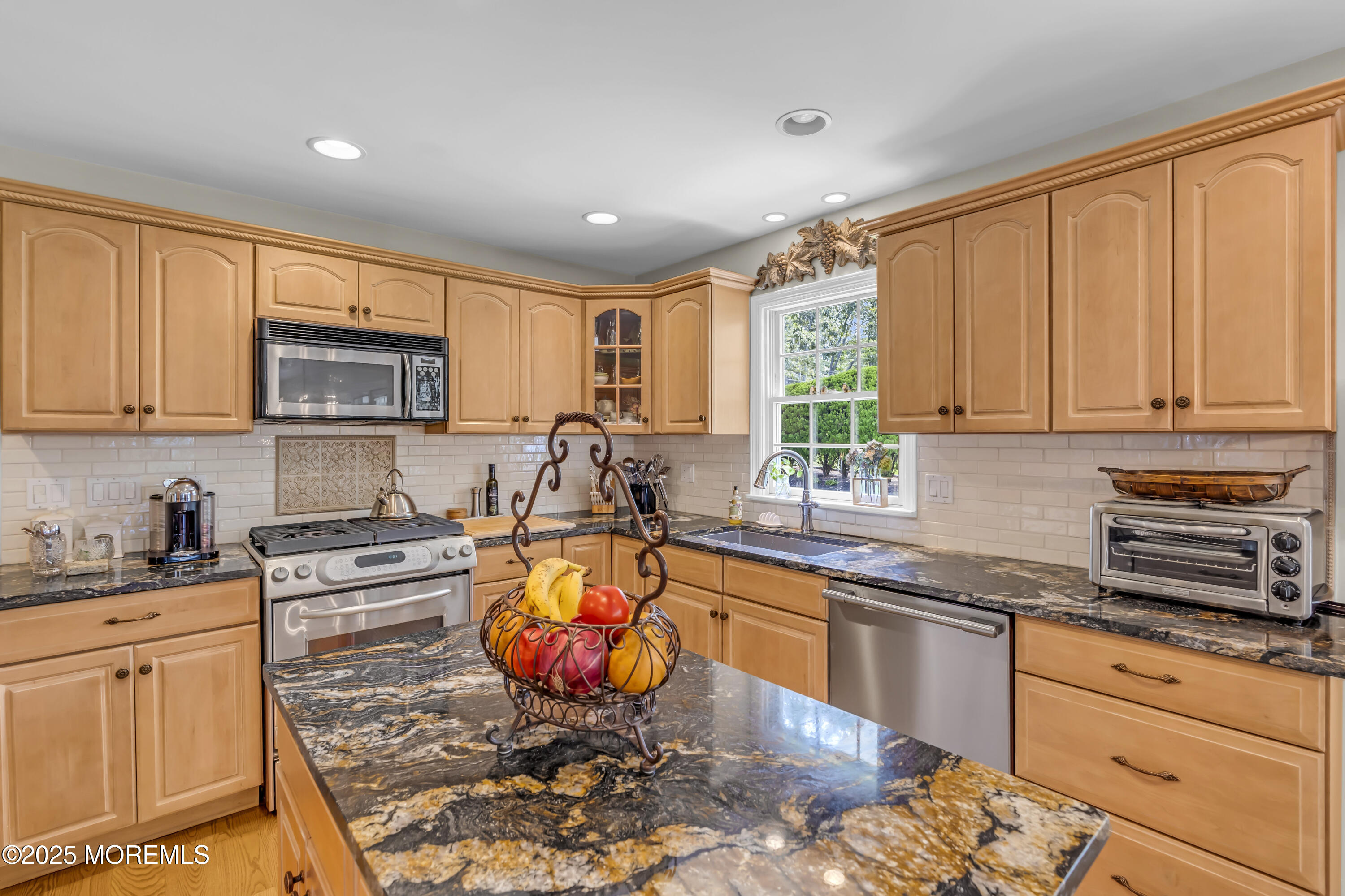 664 Valley Road Brielle, NJ 08730 - Photo 26 of 46 a kitchen with stainless steel appliances granite countertop a stove a sink dishwasher and a microwave oven with granite countertops