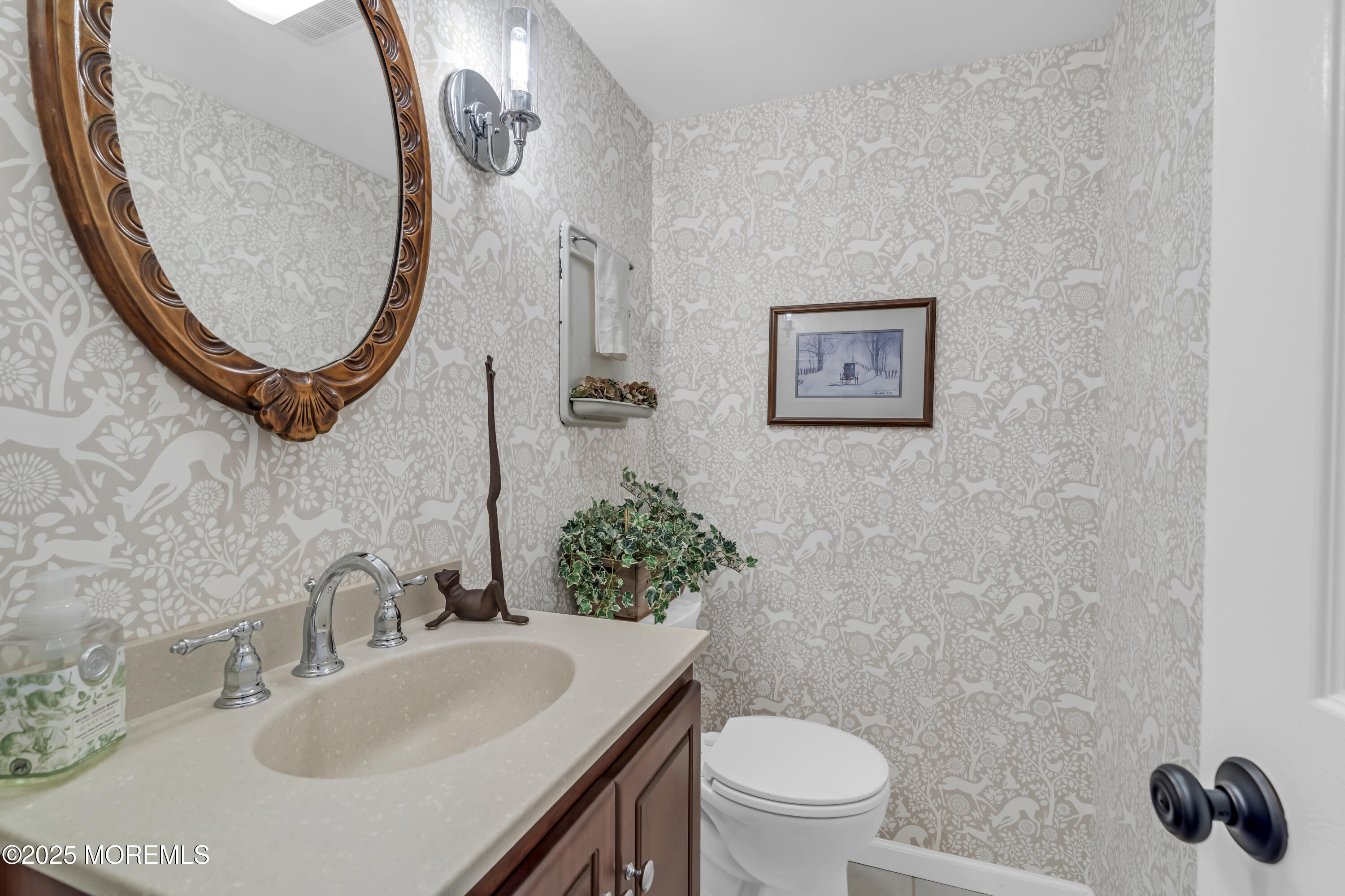 664 Valley Road Brielle, NJ 08730 - Photo 29 of 46 a bathroom with a toilet a sink and mirror
