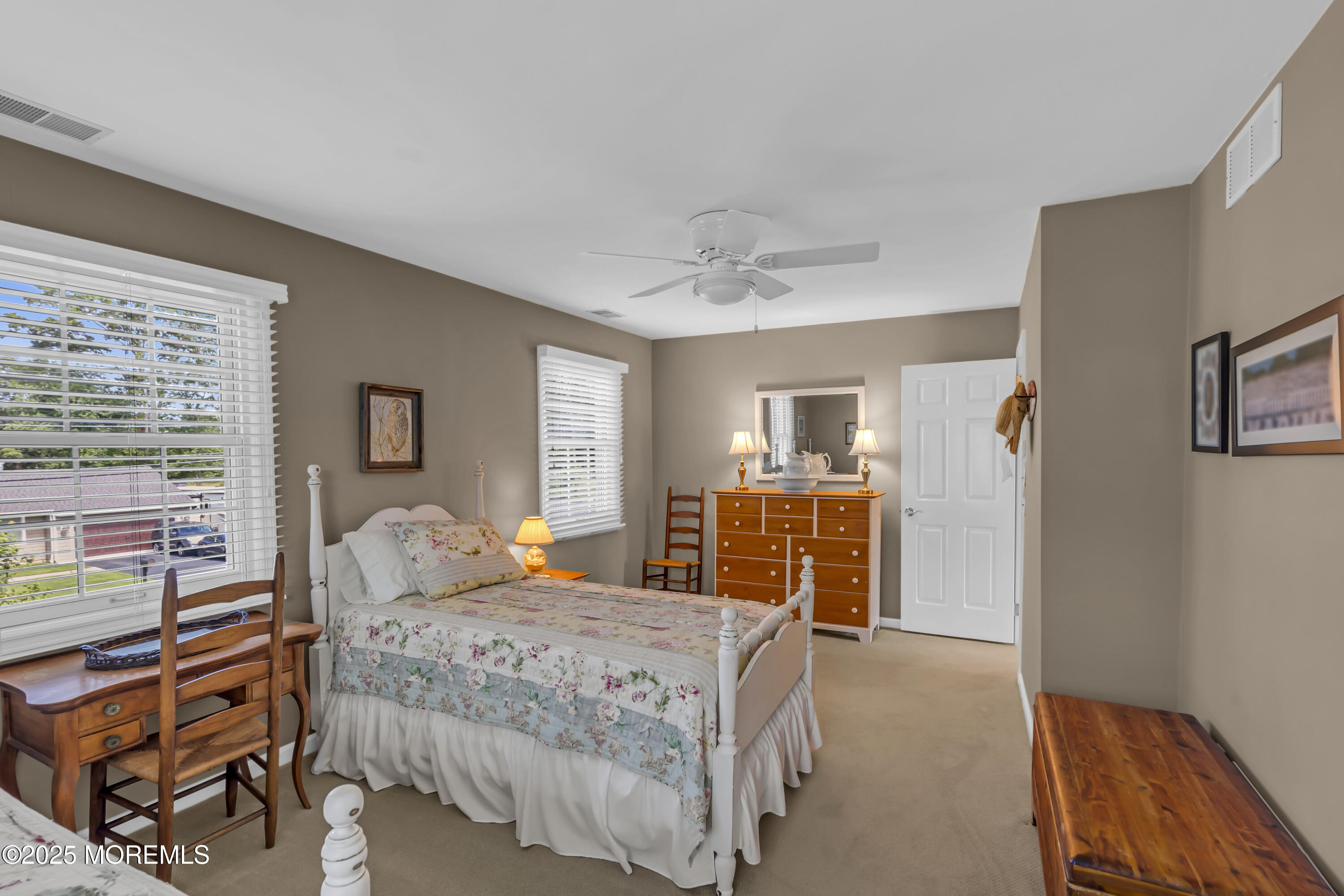 664 Valley Road Brielle, NJ 08730 - Photo 35 of 46 a bedroom with a large bed a chandelier and dresser