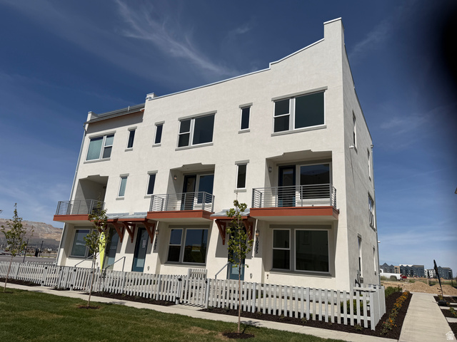 View of building exterior with a fenced front yard