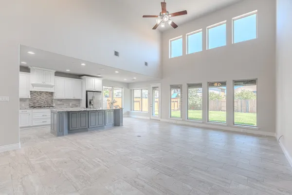a bathroom with a granite countertop sink a mirror and a shower