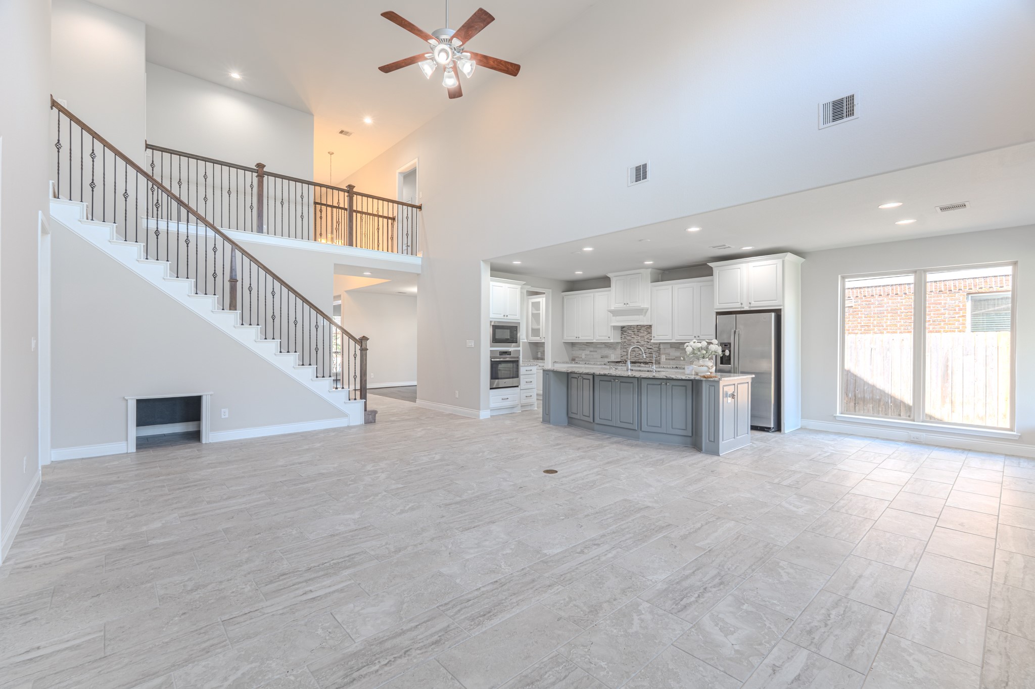 27918 Madison Bend Drive Spring, TX 77386 - Photo 15 of 50 a view of an empty room with wooden floor and a kitchen