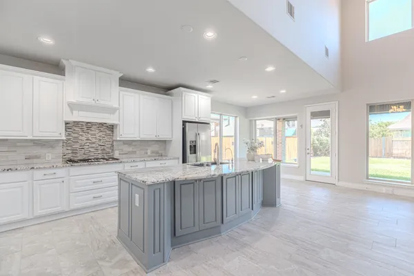 an empty room with chandelier fan