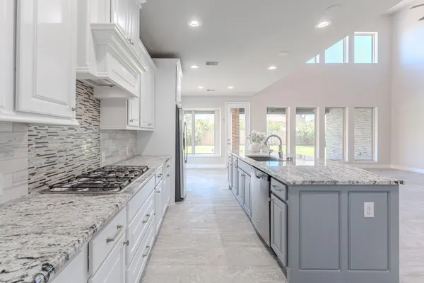 a bathroom with a granite countertop sink a toilet and bathtub