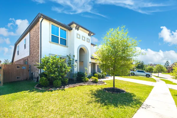 a front view of a house with a yard
