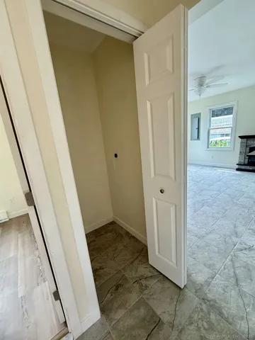 a view of a hallway with a wooden door