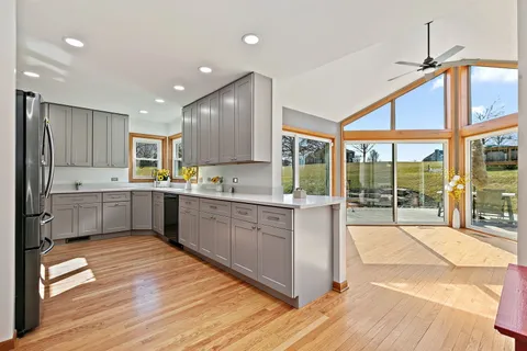 a kitchen with a refrigerator a sink and cabinets