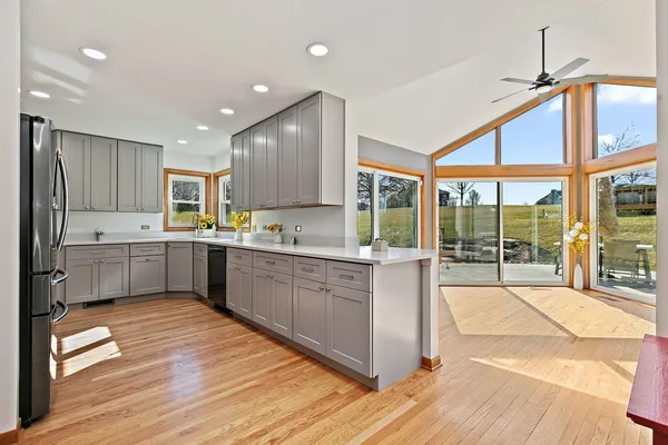 a kitchen with a refrigerator a sink and cabinets