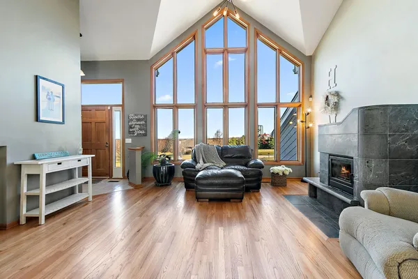 a living room with furniture a fireplace and a wooden floor