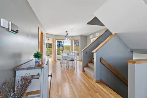 a view of entryway and hall with wooden floor