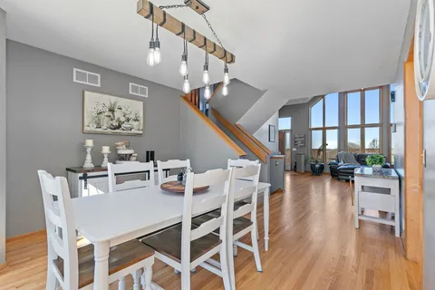 a view of a dining room with furniture wooden floor and a chandelier