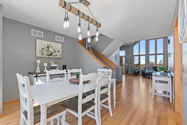 a view of a dining room with furniture wooden floor and a chandelier