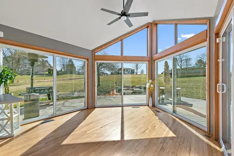 a view of a room with wooden floor and windows