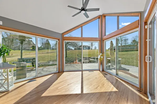 a view of a room with wooden floor and windows
