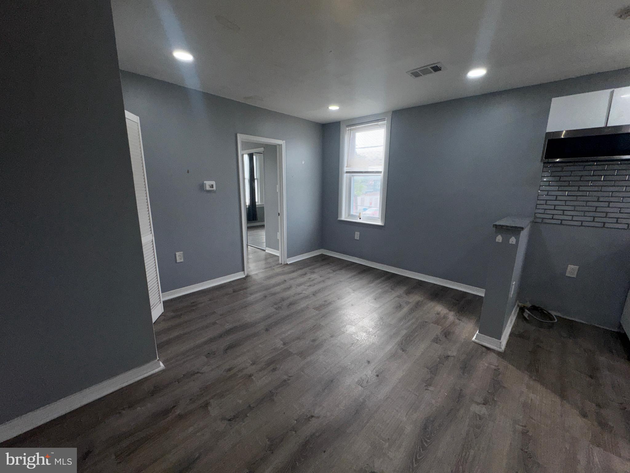 700 Lloyd Street Chester, PA 19013 - Photo 18 of 32 an empty room with wooden floor and windows