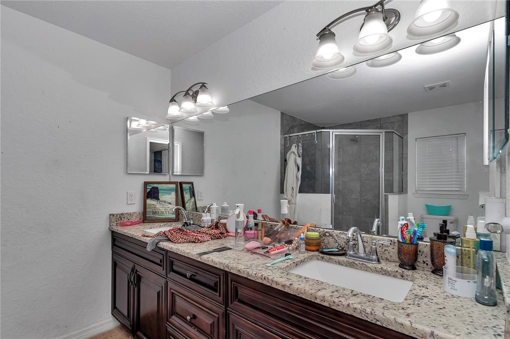 7153 Southeast 124th Street Belleview, FL 34420 - Photo 12 of 22 a bathroom with a double vanity sink and a mirror