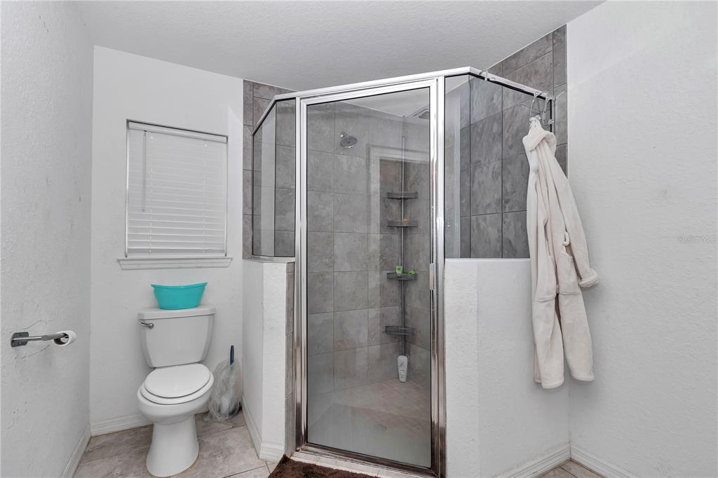 7153 Southeast 124th Street Belleview, FL 34420 - Photo 13 of 22 a bathroom that has a toilet and a shower