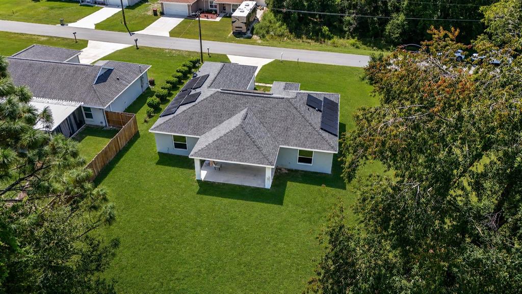7153 Southeast 124th Street Belleview, FL 34420 - Photo 15 of 16 an aerial view of a house with a garden