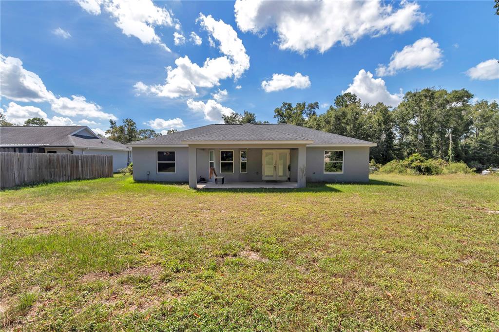7153 Southeast 124th Street Belleview, FL 34420 - Photo 19 of 22 a view of a house with a yard