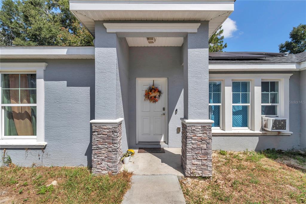 7153 Southeast 124th Street Belleview, FL 34420 - Photo 2 of 22 a front view of a house with an outdoor space