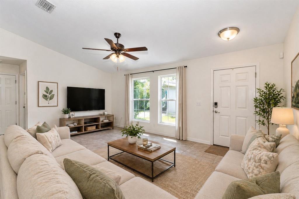 7153 Southeast 124th Street Belleview, FL 34420 - Photo 2 of 16 a living room with furniture and a flat screen tv