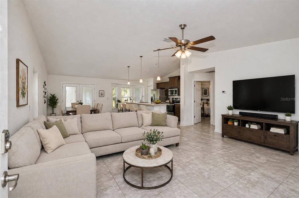 7153 Southeast 124th Street Belleview, FL 34420 - Photo 4 of 16 a living room with furniture and a flat screen tv