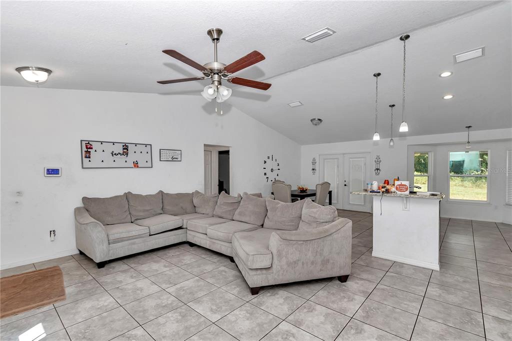 7153 Southeast 124th Street Belleview, FL 34420 - Photo 4 of 22 a living room with furniture and a chandelier