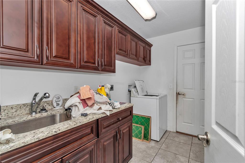 7153 Southeast 124th Street Belleview, FL 34420 - Photo 9 of 22 a kitchen with a sink cabinets and appliances