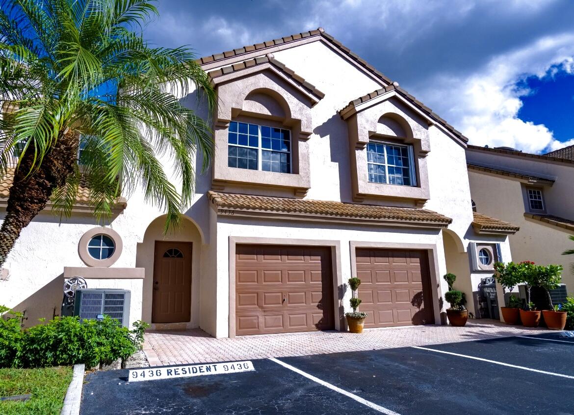 9436 Boca River Circle, Unit 9436 Boca Raton, FL 33434 - Photo 1 of 30 a front view of a house with a yard