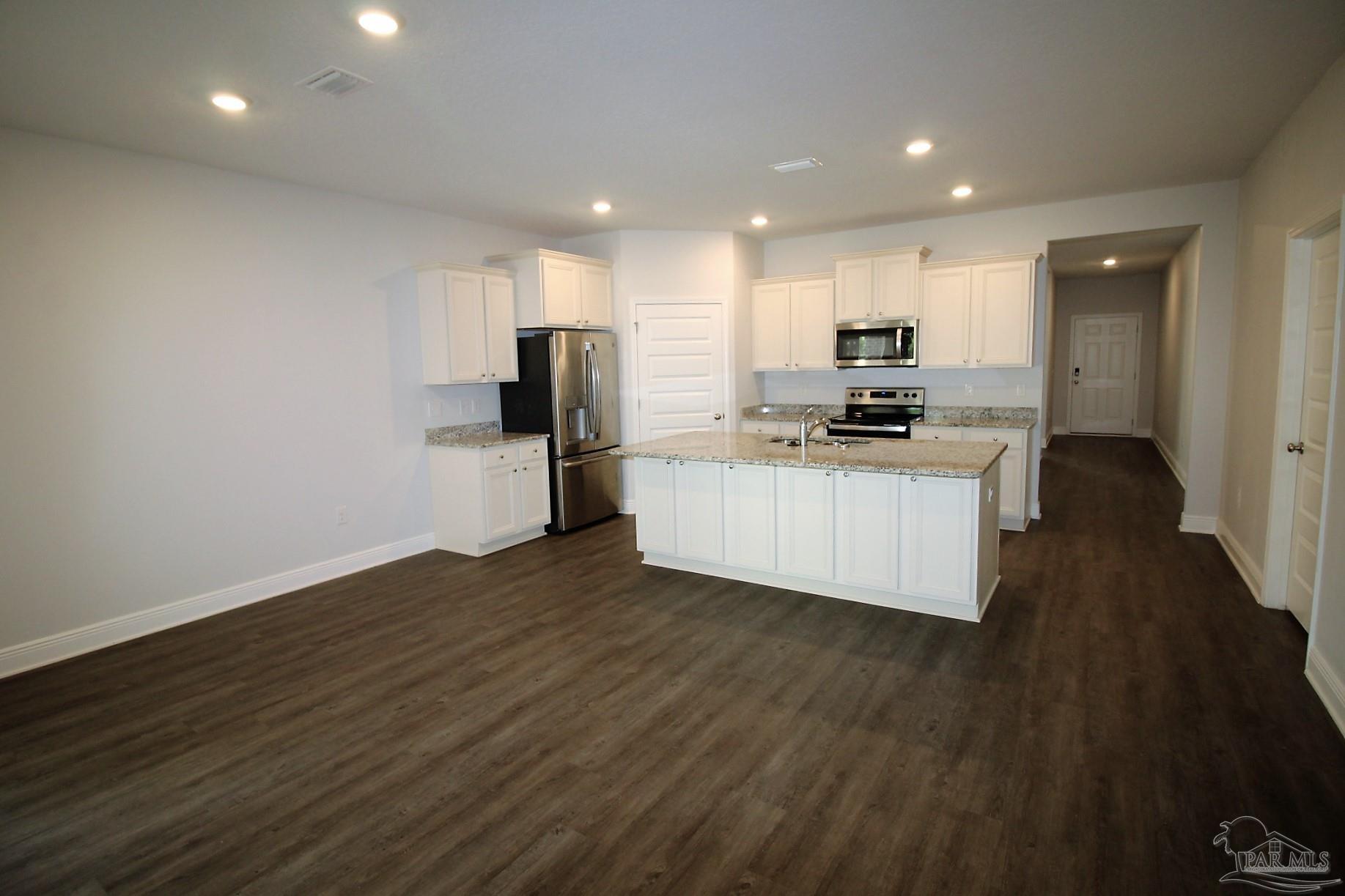 8006 Burnside Loop Pensacola, FL 32526 - Photo 9 of 22 a kitchen with stainless steel appliances a refrigerator and a stove top oven