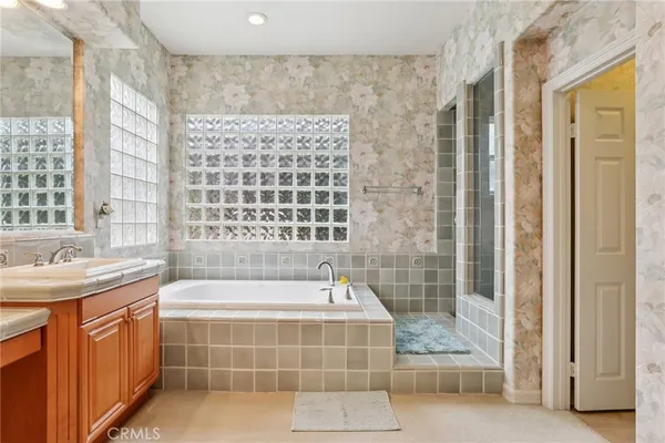 a bathroom with a tub sink and shower
