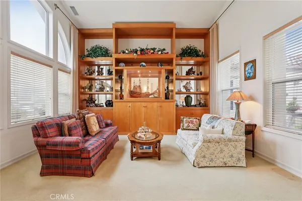 a living room with furniture and a floor to ceiling window