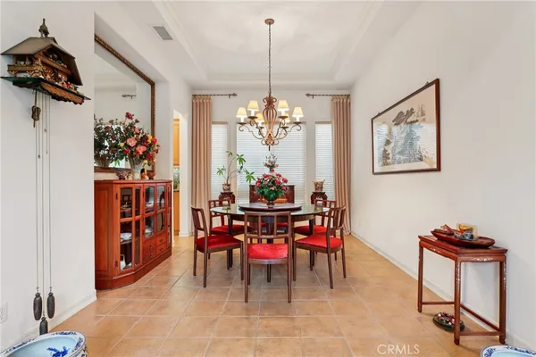 a view of a dining room with furniture and a chandelier