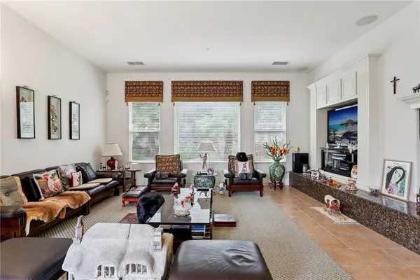 a living room with furniture and large windows