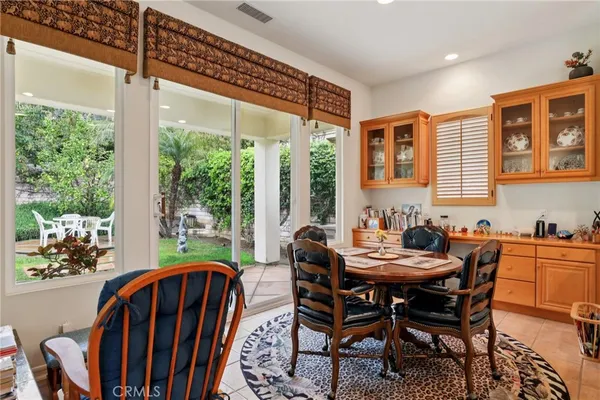 a dining room with furniture a chandelier and wooden floor