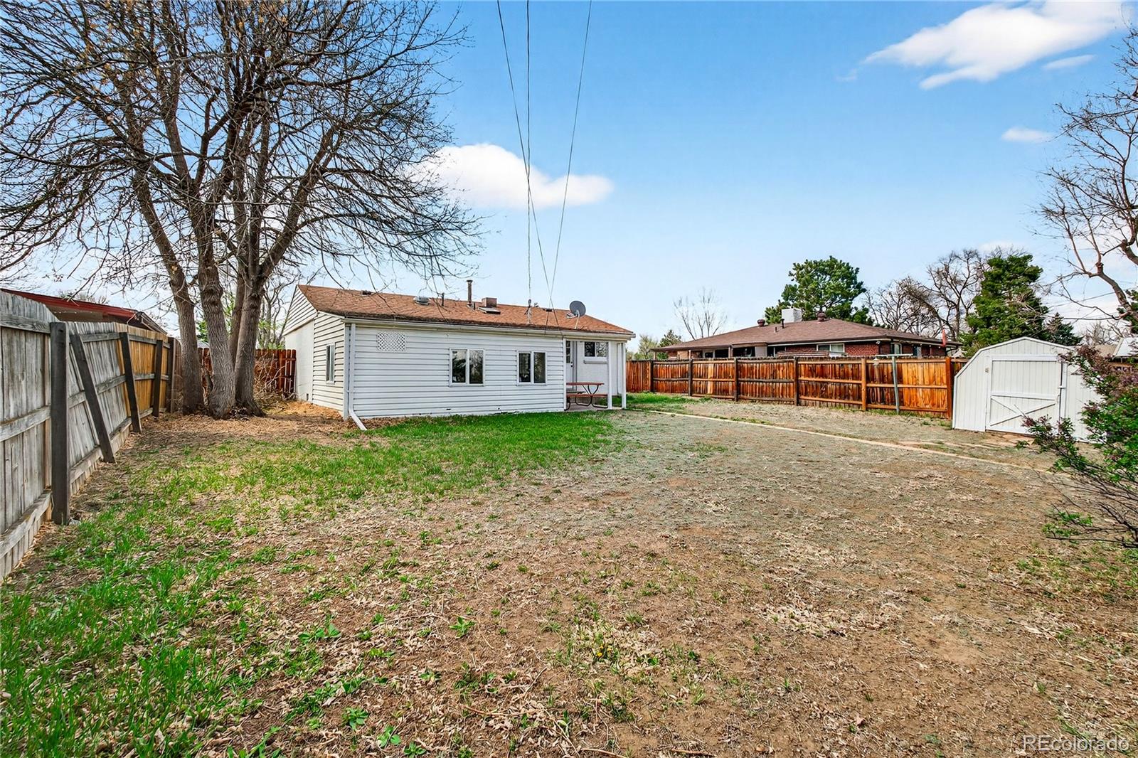 5246 Pierce Street Arvada, CO 80002 - Photo 11 of 30 a front view of house with yard and trees