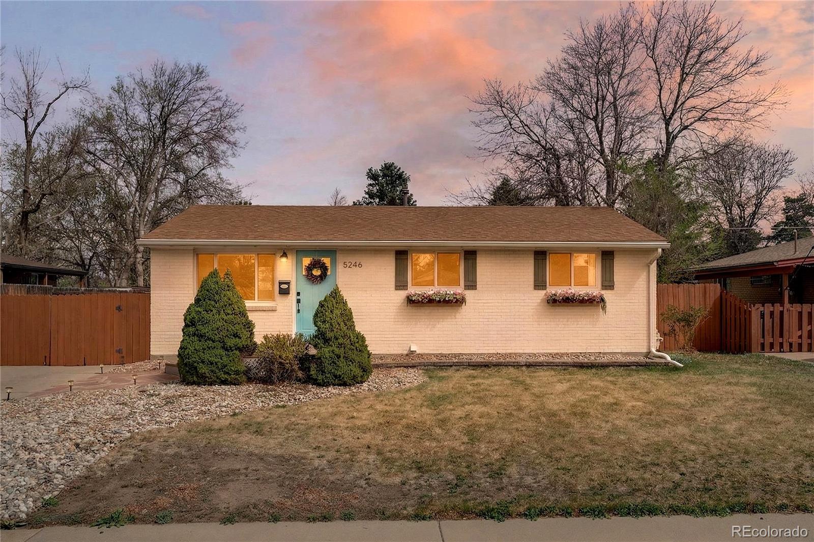 5246 Pierce Street Arvada, CO 80002 - Photo 16 of 30 a front view of a house with garden