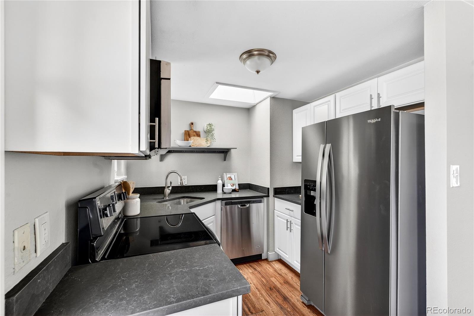 5246 Pierce Street Arvada, CO 80002 - Photo 19 of 30 a kitchen with stainless steel appliances granite countertop a refrigerator and a sink