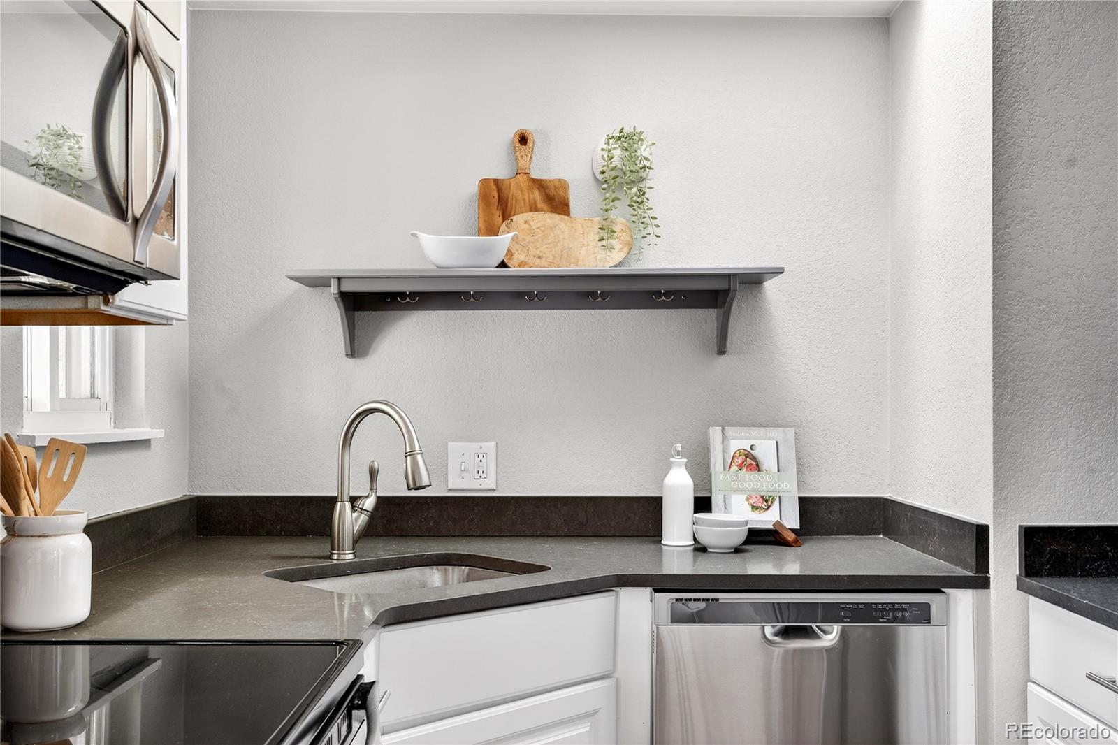 5246 Pierce Street Arvada, CO 80002 - Photo 20 of 30 a kitchen with a sink and cabinets