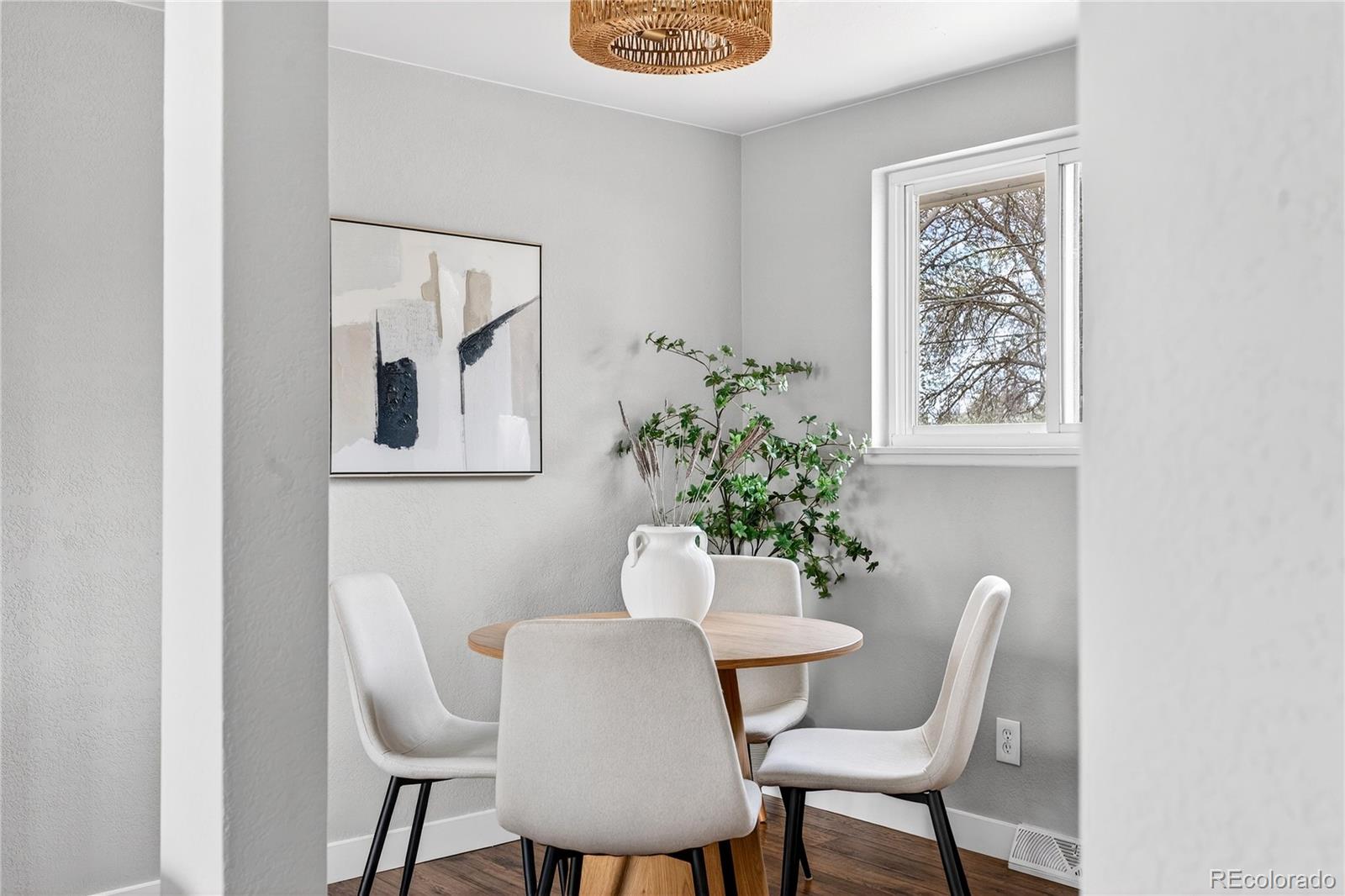 5246 Pierce Street Arvada, CO 80002 - Photo 22 of 30 a dining room with furniture and wooden floor